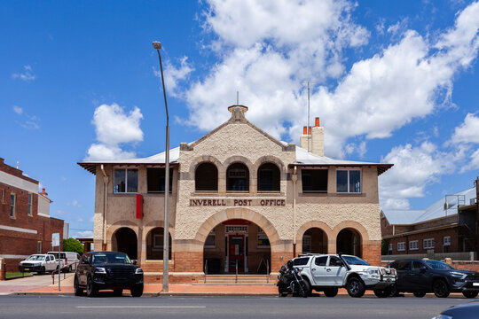 Inverell post office building in bright sunlight with cars parked along street