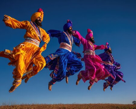 Traditional Bhangra dancers in full regalia mid-jump against a vivid saffron sky at golden hour, phulkari embroidery details sharp, turbans in deep royal blue and fuchsia, wide-angle lens, 