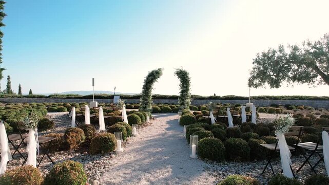 Elegant oceanfront ceremony with lush greenery. Sundrenched coastal wedding with natural floral adornments