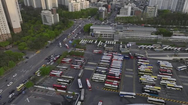 Aerial view of Seoul Express Bus Terminal at sunset with heavy traffic and city lights, Gangnam, South Korea.