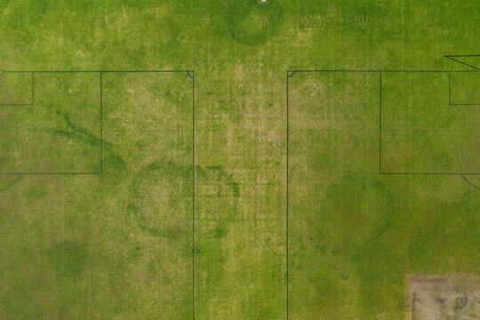Aerial drone view directly above sports playing field at Maitland Park Sportsground in Maitland, New South Wales, Australia showing painted field markings on green grass surface.