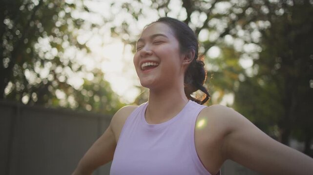 Asia young Gen Z people mindful happy woman open arm relax body deep stress relief outdoor nature green public park sun light self love anti aging life asian female mental health care modern medical.