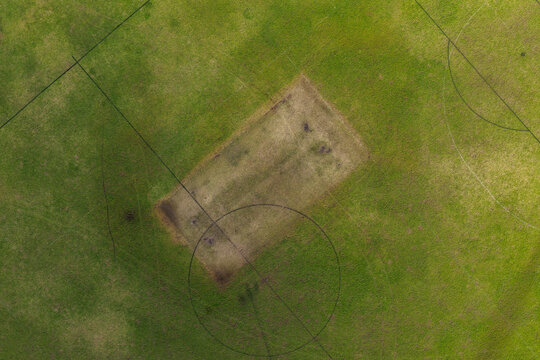 Aerial drone view directly above sports playing field at Maitland Park Sportsground in Maitland, New South Wales, Australia showing painted field markings on green grass surface.