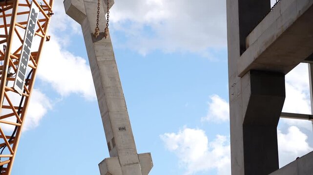 Crane lifting precast concrete column into position
