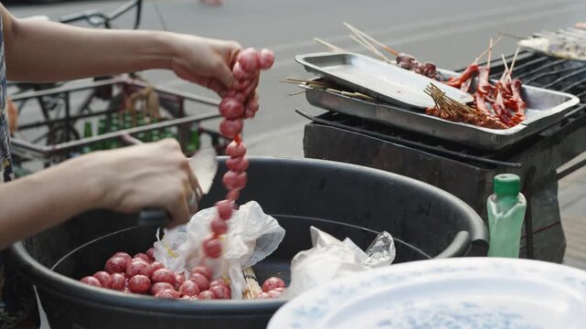 Vendor Slicing Chorizo for Street Food BBQ Setup