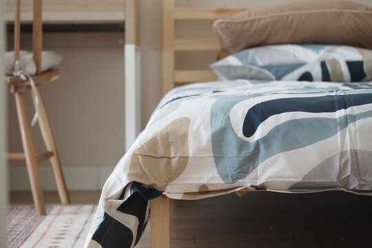 Warm bedding on a wooden bed in a simple room