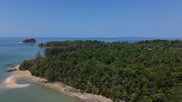 Wide aerial establishing shot of tropical coastline on Koh Jum Thailand showing sandy beach clear calm water and green vegetation peaceful island landscape ideal for travel and film projects