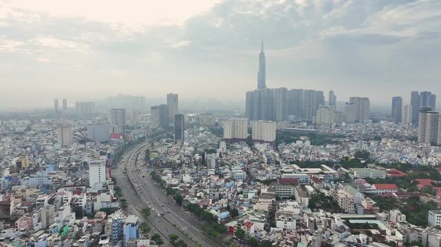Aerial view of urban traffic and residential area with Landmark 81 in Ho Chi Minh City under morning haze