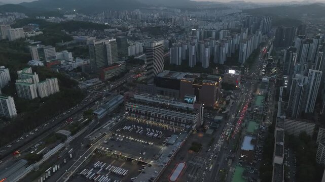 Aerial view of Seoul Express Bus Terminal at sunset with heavy traffic and city lights, Gangnam, South Korea.