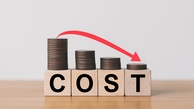 A bar graph made of wooden blocks and coins showing a decrease in cost over time.