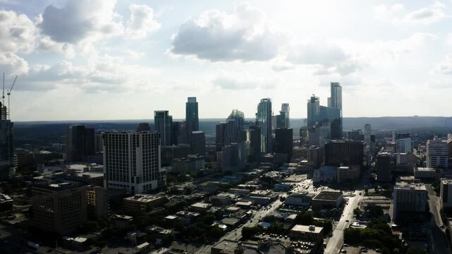 Aerial view of the sprawling Austin, Texas city with cars commuting to work in the early morning sunshine.