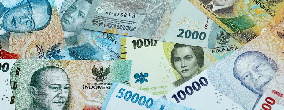 Indonesian rupiah money banknotes pile on table. Indonesia bills of IDR currency close up