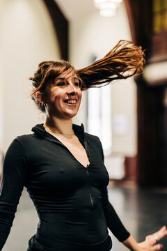 Female dancer moving hair during studio rehearsal
