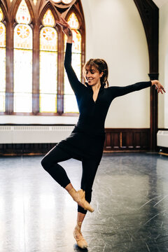 Young female ballet dancer practicing pointe work in studio