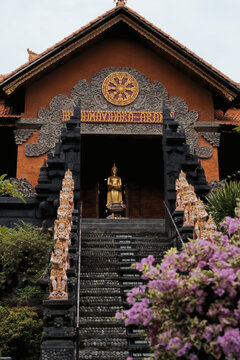 Brahmavihara Arama main temple facade with golden Buddha statue, Bali