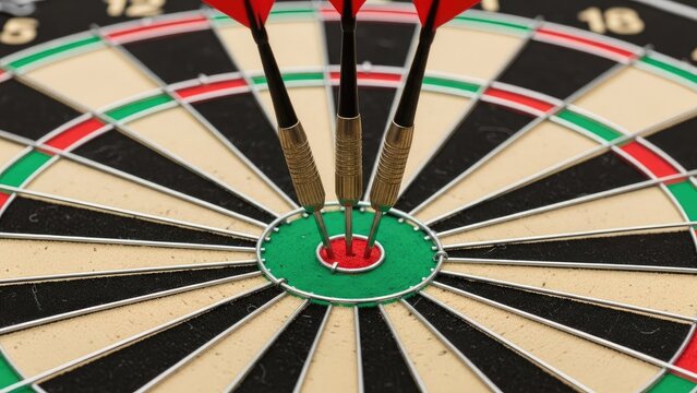 A close-up of a dartboard with three darts hitting the bullseye