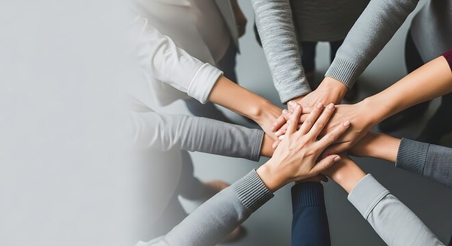 Hands stacked together in a show of unity and teamwork with teamwork, together