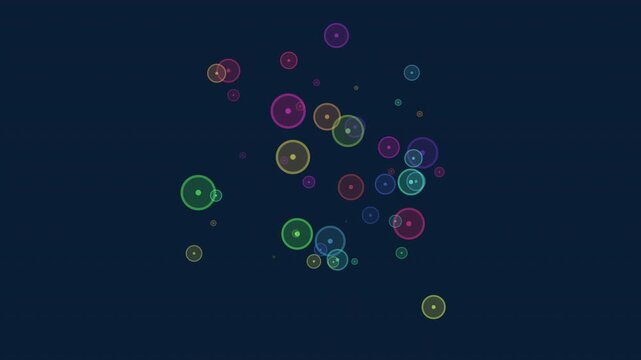 Abstract footage of multicolored glowing circles and bubble outlines drifting on a dark blue background, creating a soft bokeh effect for modern motion design