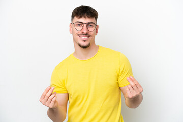 Naklejka premium Young caucasian handsome man isolated on white background making money gesture