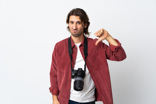 Young photographer man isolated on white background showing thumb down with negative expression