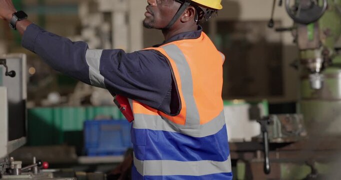 A technician performs precision grinding and close inspection on a metal component in a manufacturing facility, showing finishing work, process control, and industrial supervision.
