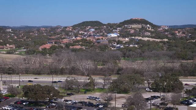 The Dominion is one of the most affluent communities of Texas and is located in the Northwest quadrant of San Antonio. Drone footage captures nearby Interstate I-10 with bustling traffic.