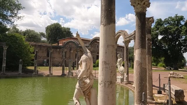 Scenic view of Villa Adriana Canopus reflecting pool with classical marble statues and ancient Roman columns at Hadrian's Villa in Tivoli, Italy.