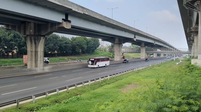 Urban Highway Traffic Under Elevated Overpass in Daylight