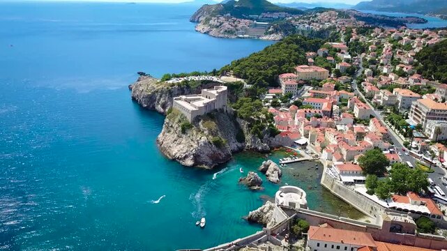 The old city of Dubrovnik sits on the coastline of Croatia with beautiful views of the Adriatic Sea. It's a medieval fortified town with castle walls and monasteries mixed with European urban life.
