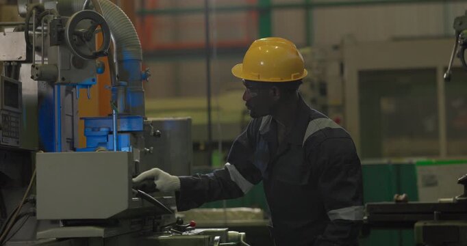 A technician performs precision grinding and close inspection on a metal component in a manufacturing facility, showing finishing work, process control, and industrial supervision.
