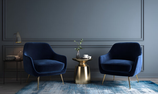 Two plush blue chairs face each other near a gold side table with a plant and cups, in a room with a blue-gray wall