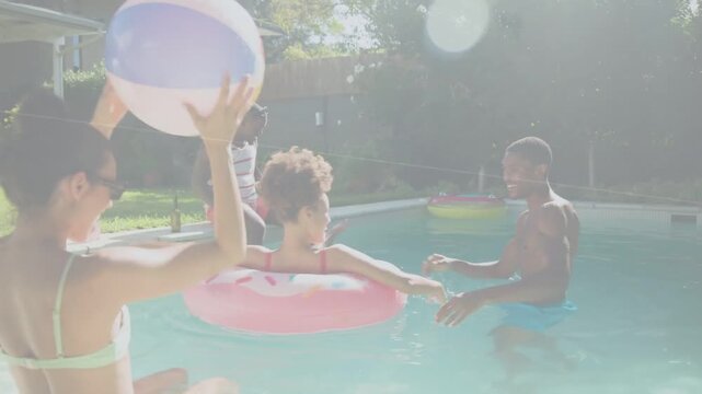 Seated man tossing striped beach ball friends reaching as man guiding pink donut float for leisure