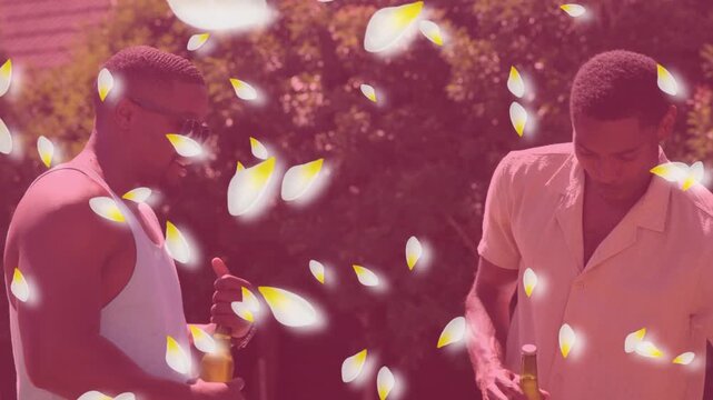 Two men chatting in yard, one opening bottle to toast while petals drifting over bottles, marketing