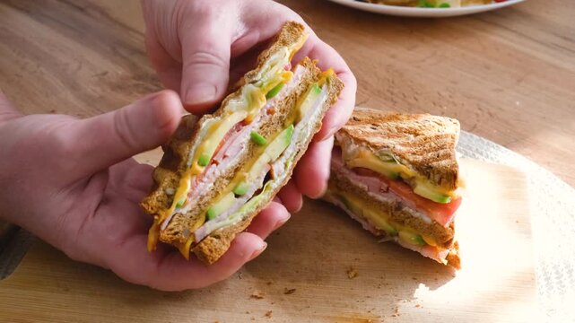 Club sandwiches with guacamole and fresh vegetables show the cut