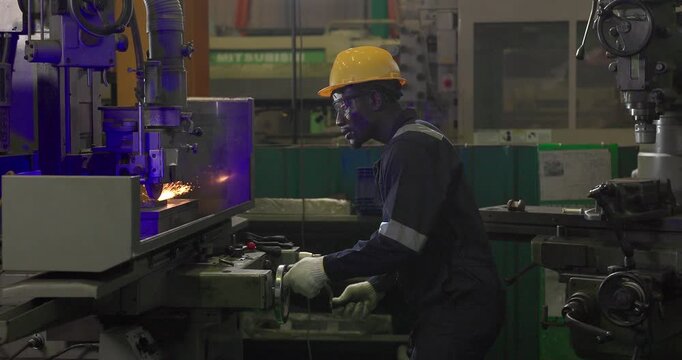 A technician performs precision grinding and close inspection on a metal component in a manufacturing facility, showing finishing work, process control, and industrial supervision.
