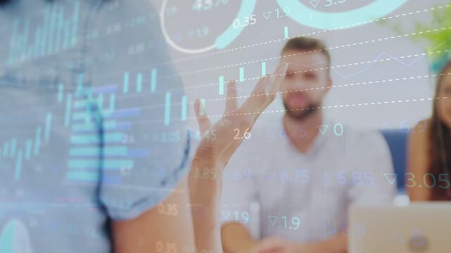 Presenter raising hand and speaking, activating finance charts tracking hand to emphasize data