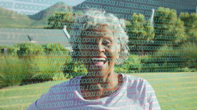Vertical video: Senior woman reacting to cam, smiling then laughing by lake, tech binary overlaying