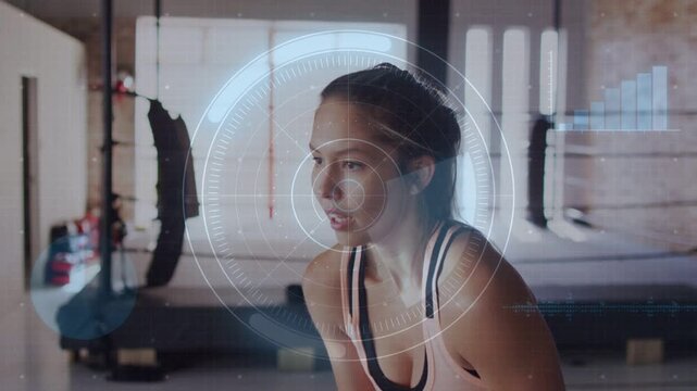 Woman bending over steadying breath post-exertion in gym, HUD circling head monitoring vitals