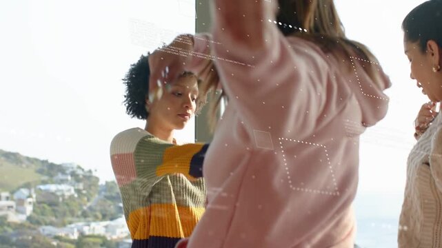 Stylist lifting brush, applying makeup to striped woman by window for styling, HUDs obscuring faces