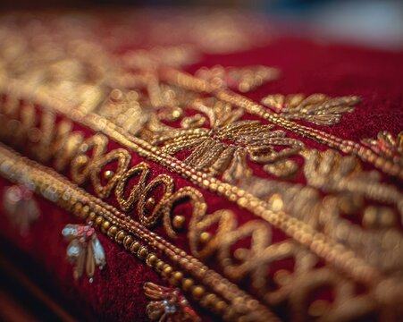 A close-up of the Palki (canopy) of the Guru Granth Sahib, rich gold embroidery on red velvet, intricate details, selective focus on the texture, soft diffused light