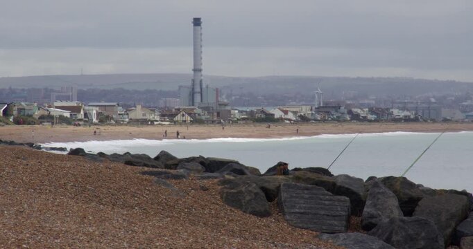 wide shot looking east up Shoreham beach with power station in background