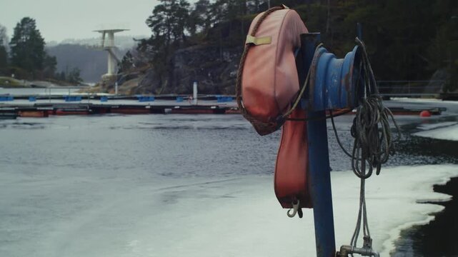 A life jacket hanging from a pole on a frozen lake in Norway