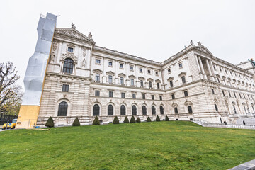 Fototapeta premium The neoclassical facade of the Neue Burg at Hofburg Palace during architectural restoration in Vienna.