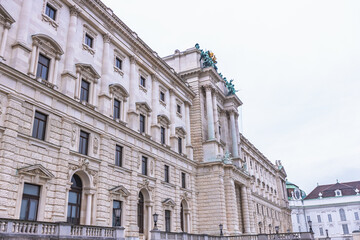 Fototapeta premium Detailed low-angle view of the ornate Neue Burg wing facade at Hofburg Palace in Vienna.