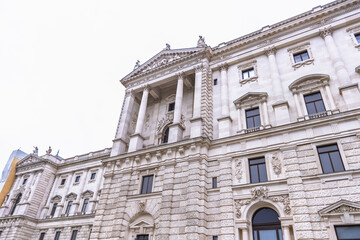 Fototapeta premium Detailed low-angle view of the ornate Neue Burg wing facade at Hofburg Palace in Vienna.
