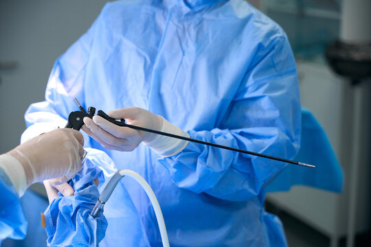 Two surgeons performing laparoscopic surgery in hospital operating room