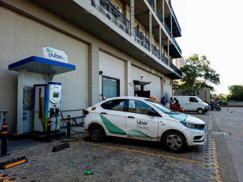 Delhi, India - 28th Mar 2026: An electric Uber cab charges at a public Jio BP Pulse EV station in Delhi, highlighting sustainable transport, clean energy adoption, and urban mobility infrastructure in