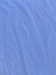 Obraz premium Soft blue cotton fabric texture background featuring delicate folds and natural shadows that create a clean minimalist surface for creative design projects