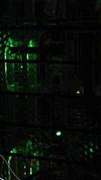 Caged electronics showing metal grille, glowing hex panel with pulsing green LEDs and white curves