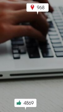 Vertical video: Hands typing for marketing, causing icons and counts popping over keys and cup